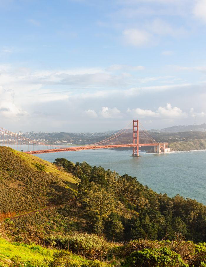 home-img A breathtaking view of the Golden Gate Bridge spanning the San Francisco Bay, framed by lush hills.