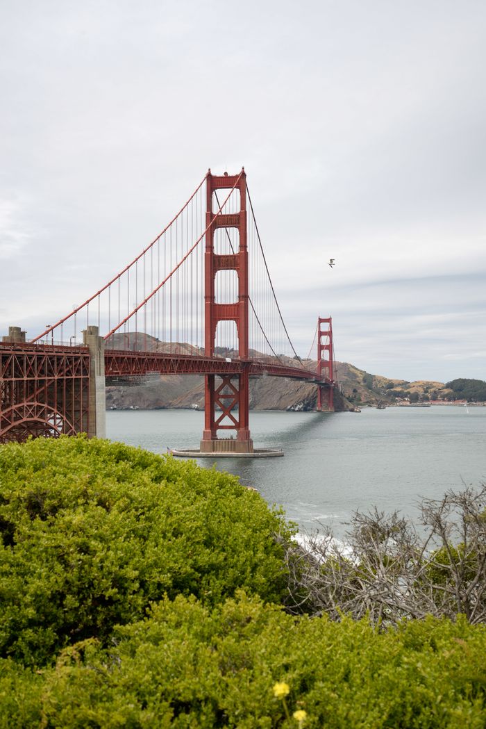 Scenic view of the iconic Golden Gate Bridge in San Francisco under a cloudy sky.