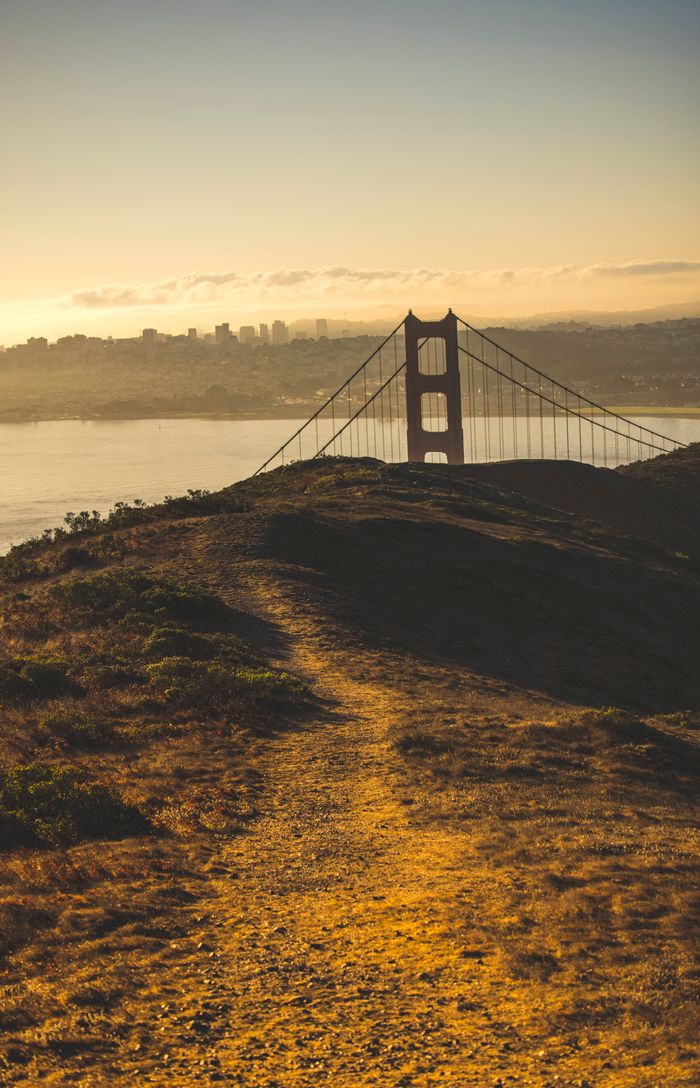 services-01 Stunning view of the iconic Golden Gate Bridge during sunset with San Francisco skyline in the background.